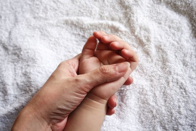 Mother holding kid's hand