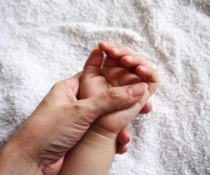 Mother holding kid's hand